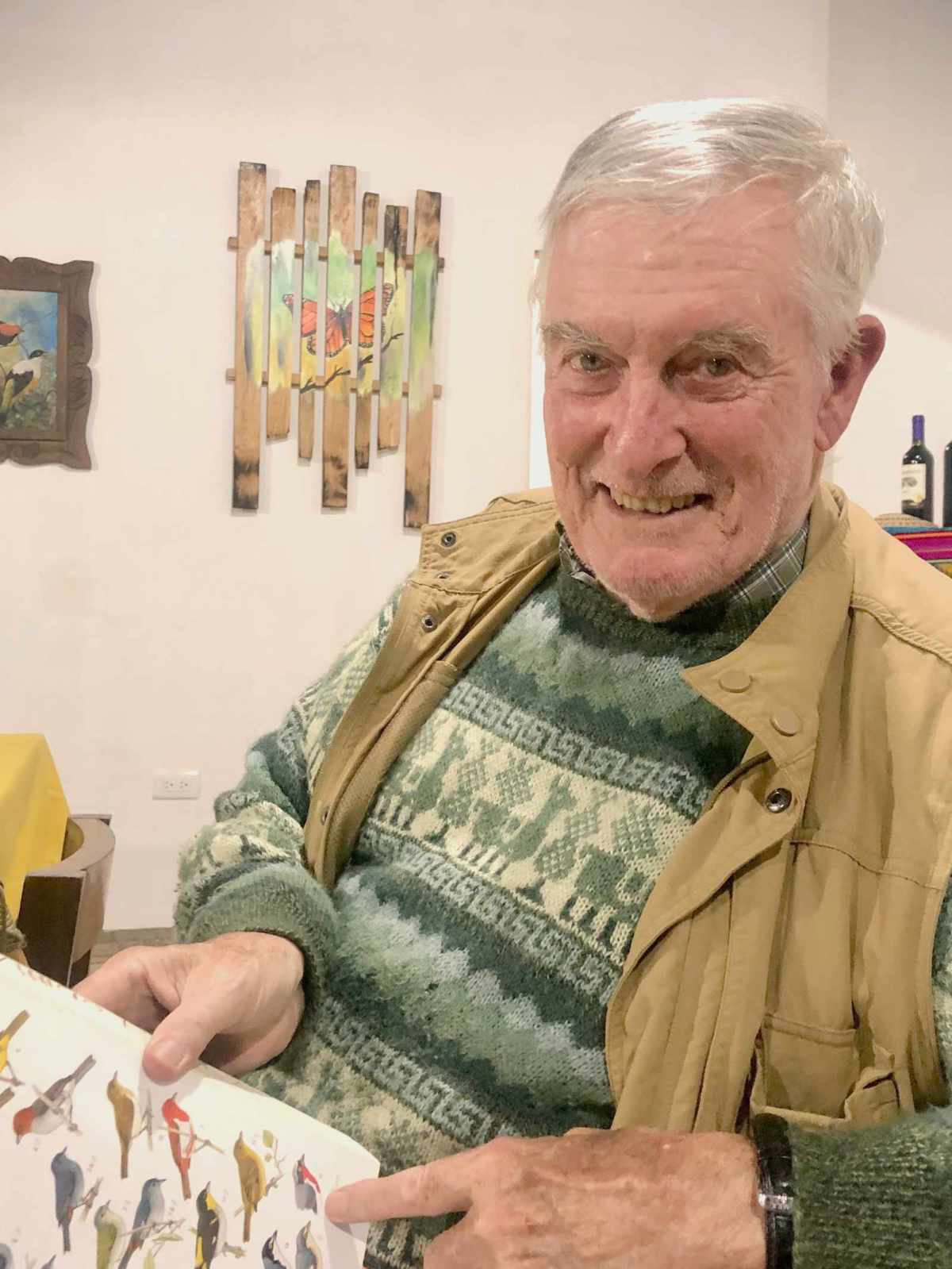 Dr. Robert Ridgely pointing to a page in his book Birds of Ecuador.